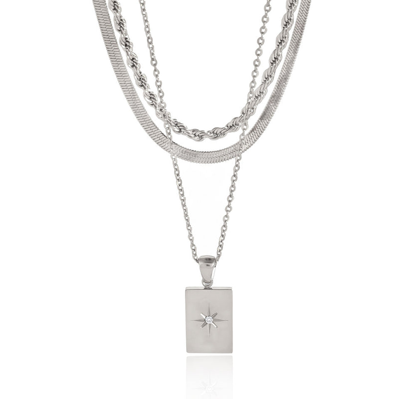 Layered silver-tone chains with a rectangular starburst pendant