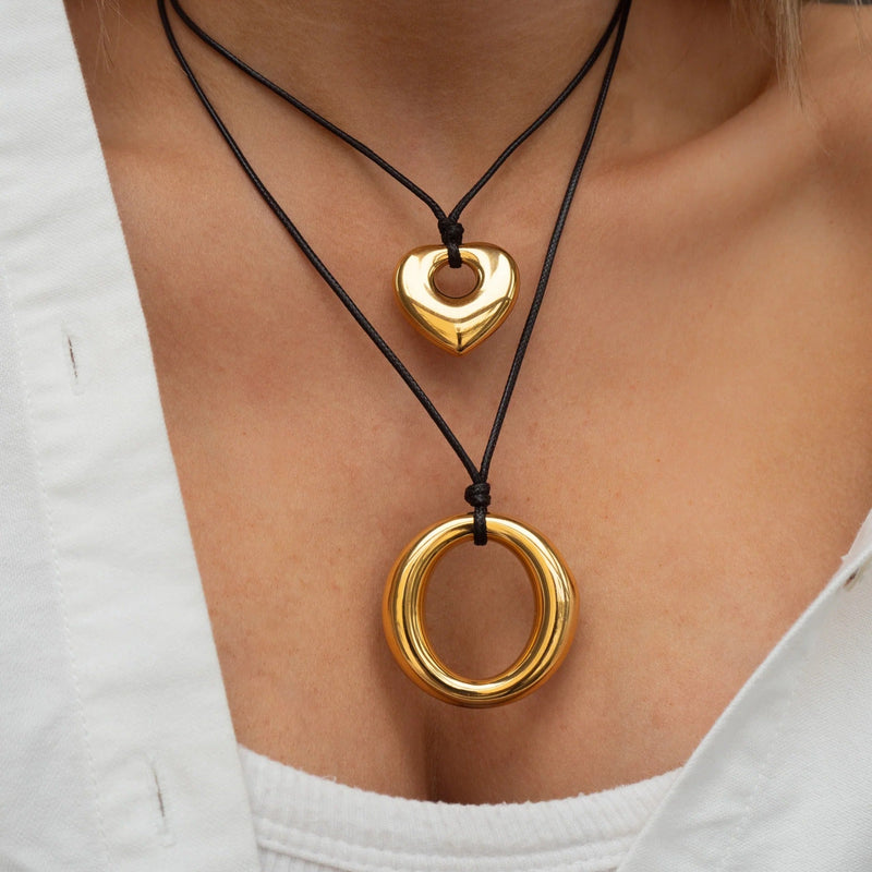 Heart and ring pendant cord necklaces worn layered