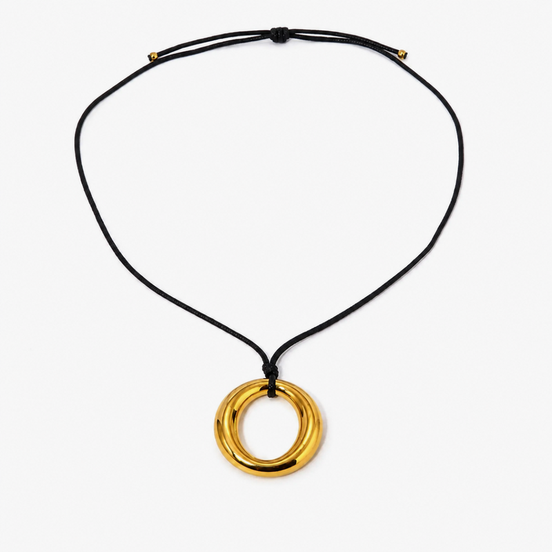 Gold-tone open circle pendant on a black cord
