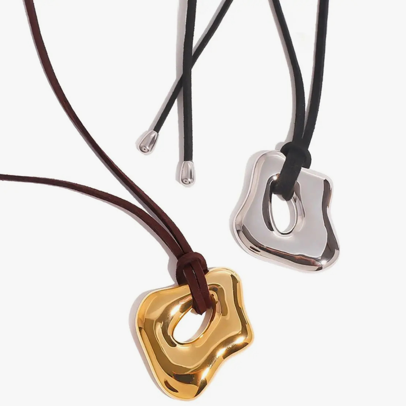 Sculptural open pendants on brown and black cords, in gold and silver tone