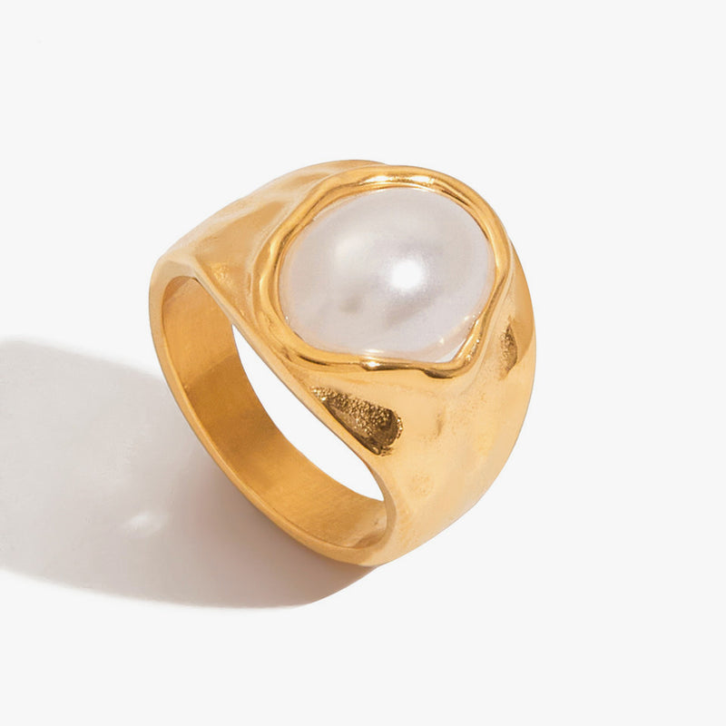 Chunky gold-tone ring set with a large white domed stone