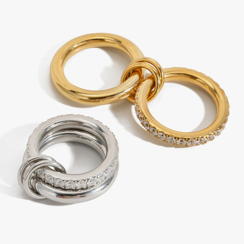 Interlocking triple rings in gold and silver tone with a crystal band
