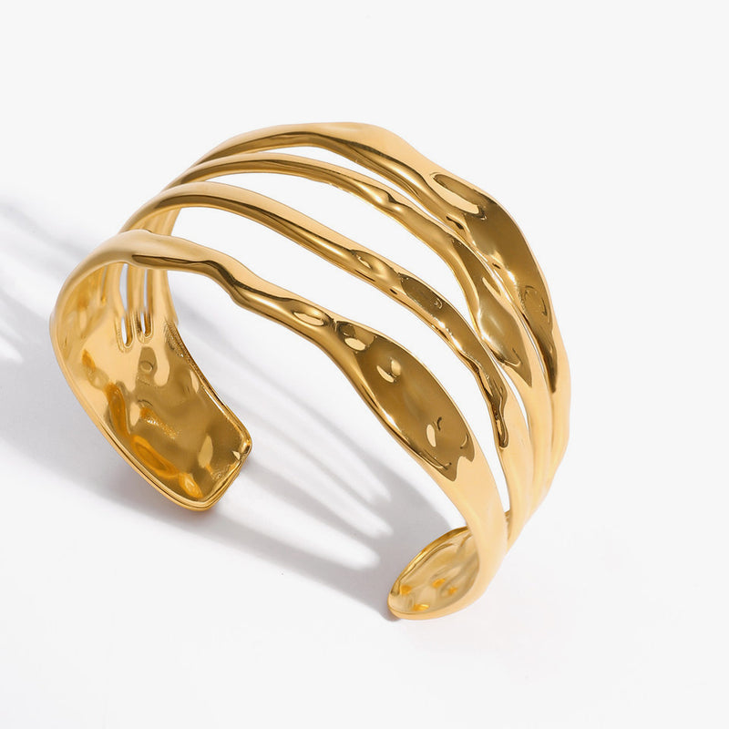 Wide hammered cuff formed from several stacked bands