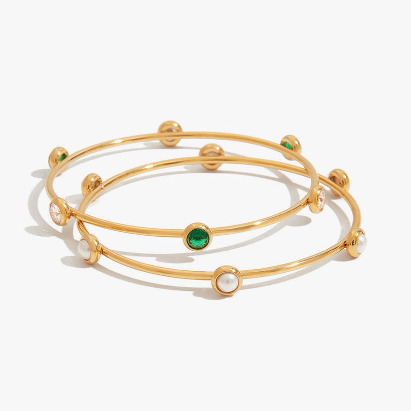 Two slim bangles set with green stones and small pearls