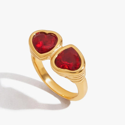 Gold-tone ring set with two red heart-cut crystals